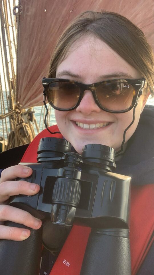Erin Hudson Brown on Excelsior with binoculars